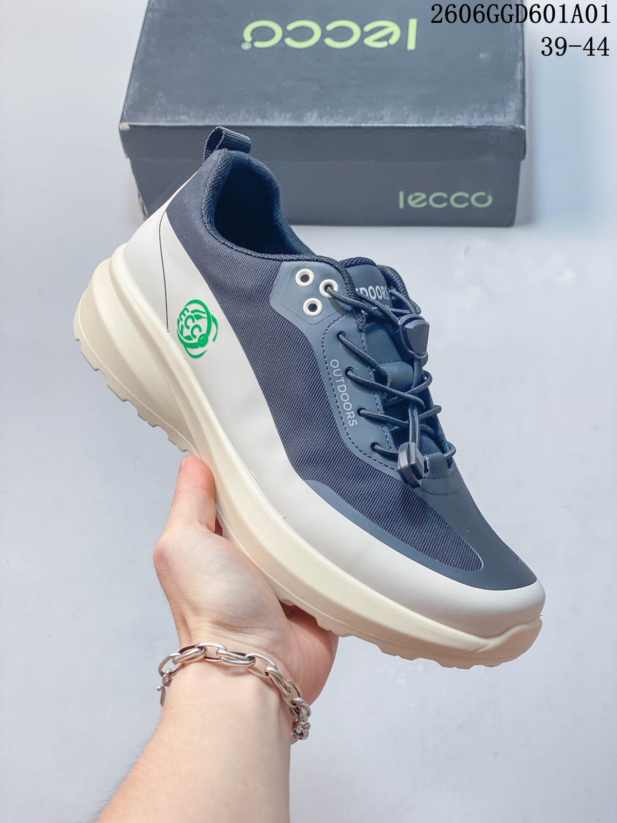 Angled side view showing the sneaker's navy and grey panels and green heel emblem