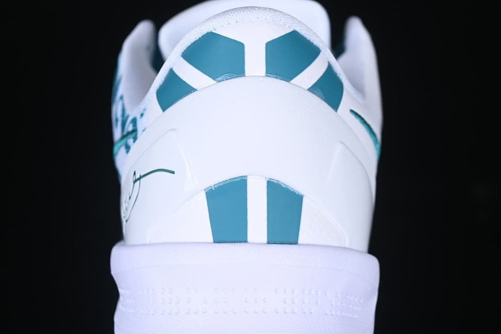 Rear view showing teal heel accents on the white shoe