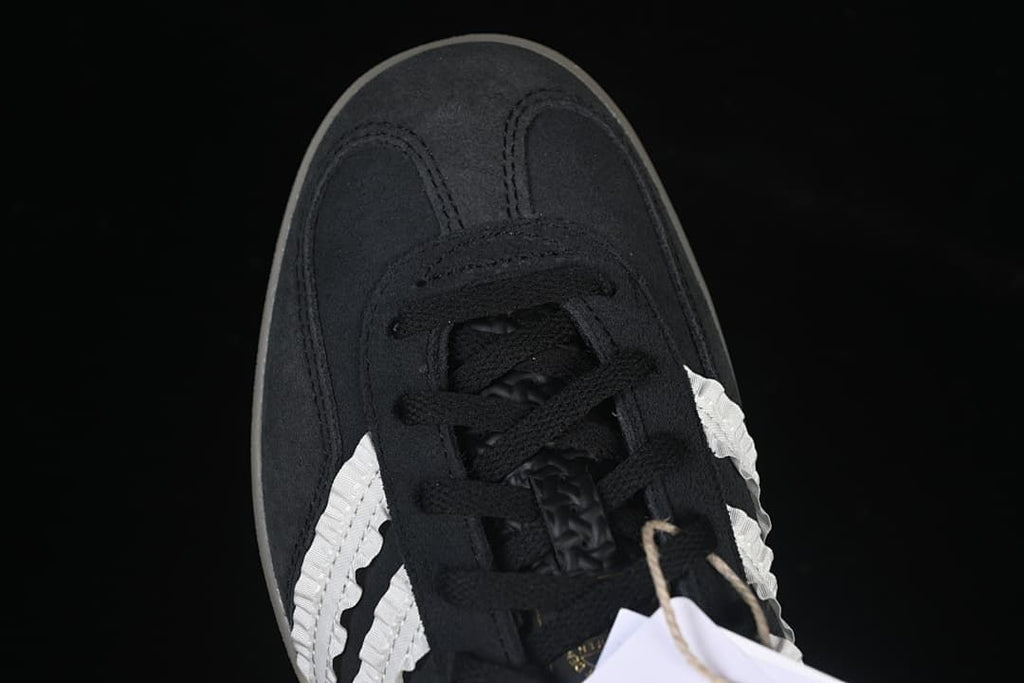 Top-down view of the black toe, laces and white side stripes.