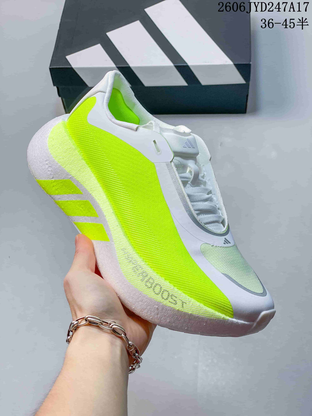 Angled close-up of the sneaker’s side, neon-lime panels, and sculpted sole