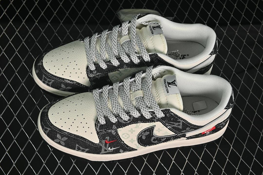 Top view of a pair of cream and black low-top sneakers with patterned laces and printed panels.