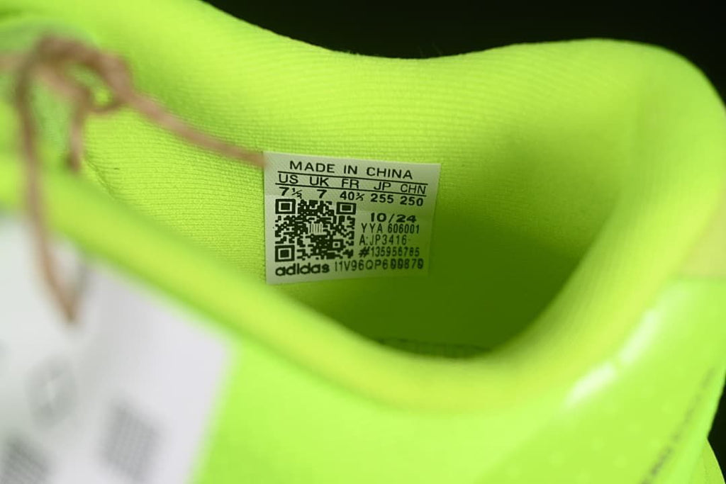 Interior size label on the neon yellow Adidas shoe.