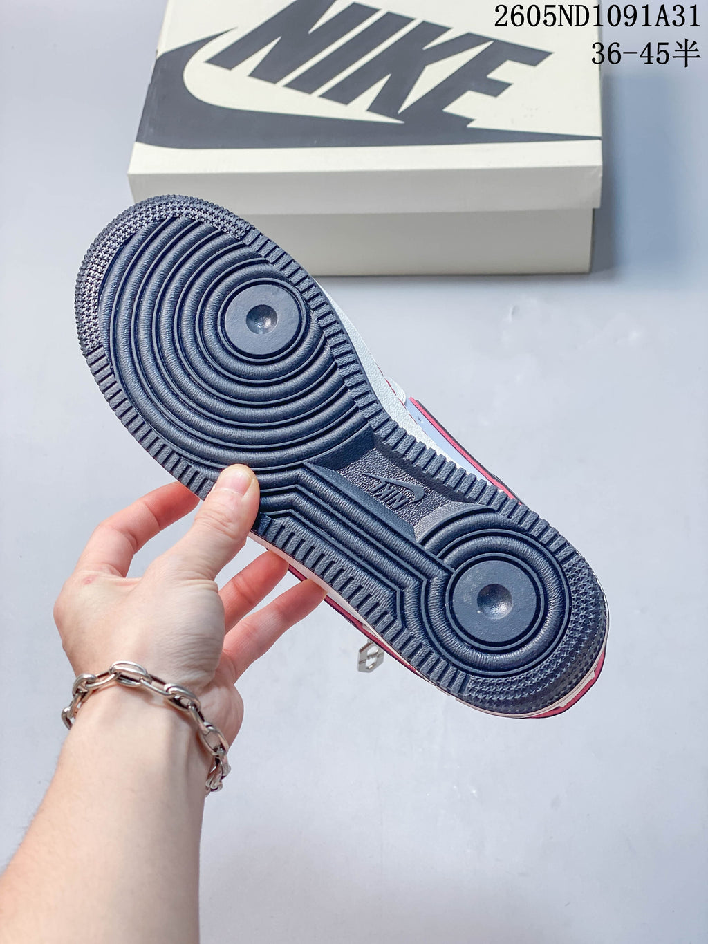 Close view of the dark outsole with circular tread patterns.