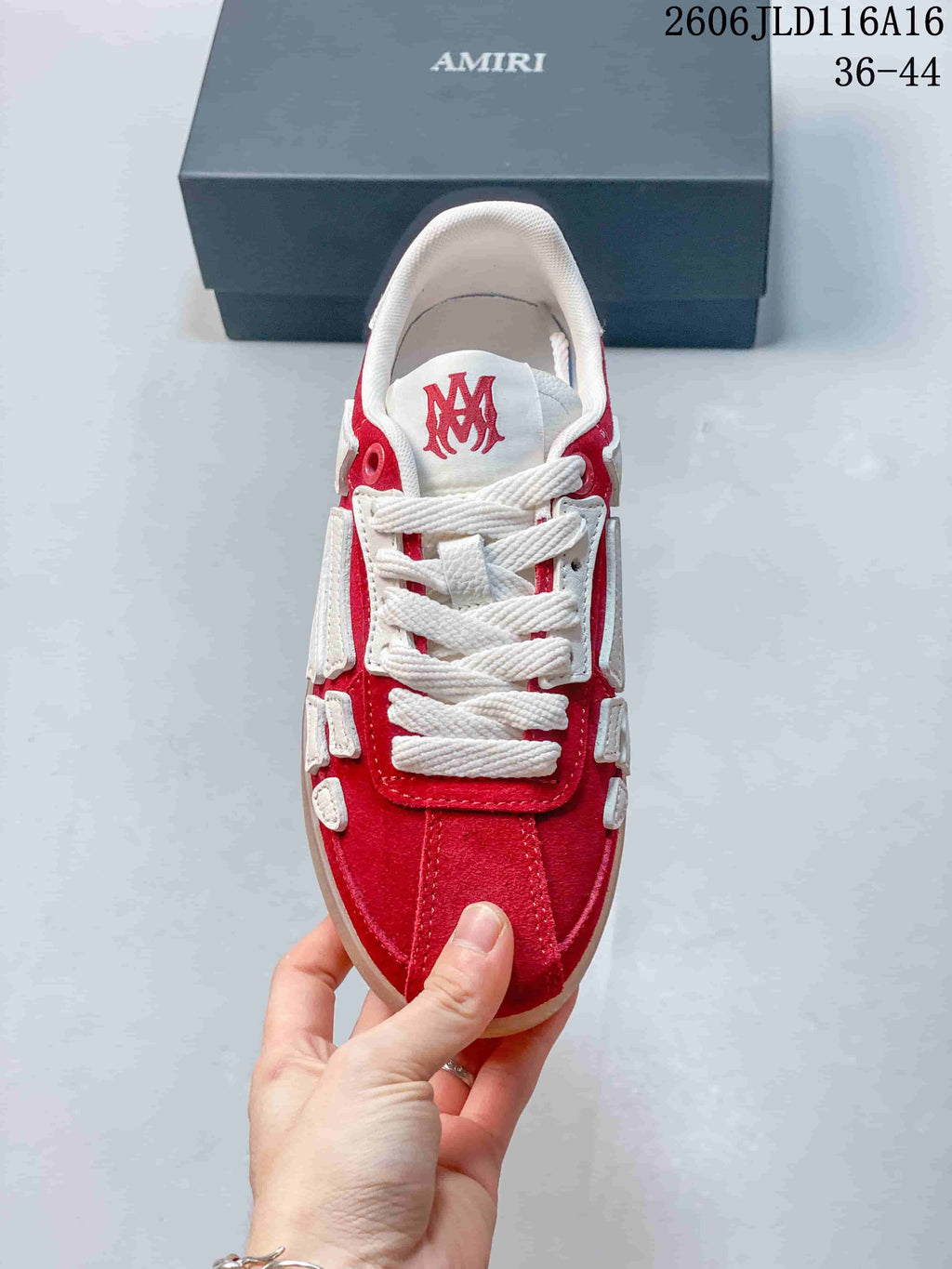 Top view showing white laces and red tongue emblem