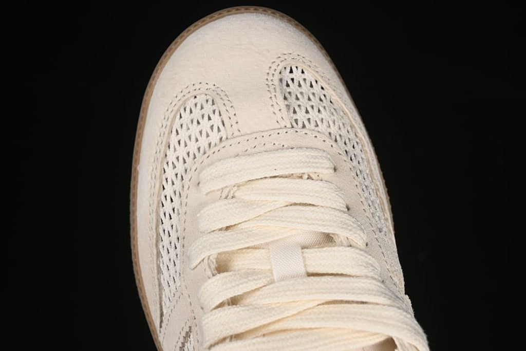 Top-down view of the sneaker’s toe, openwork panels and lacing.