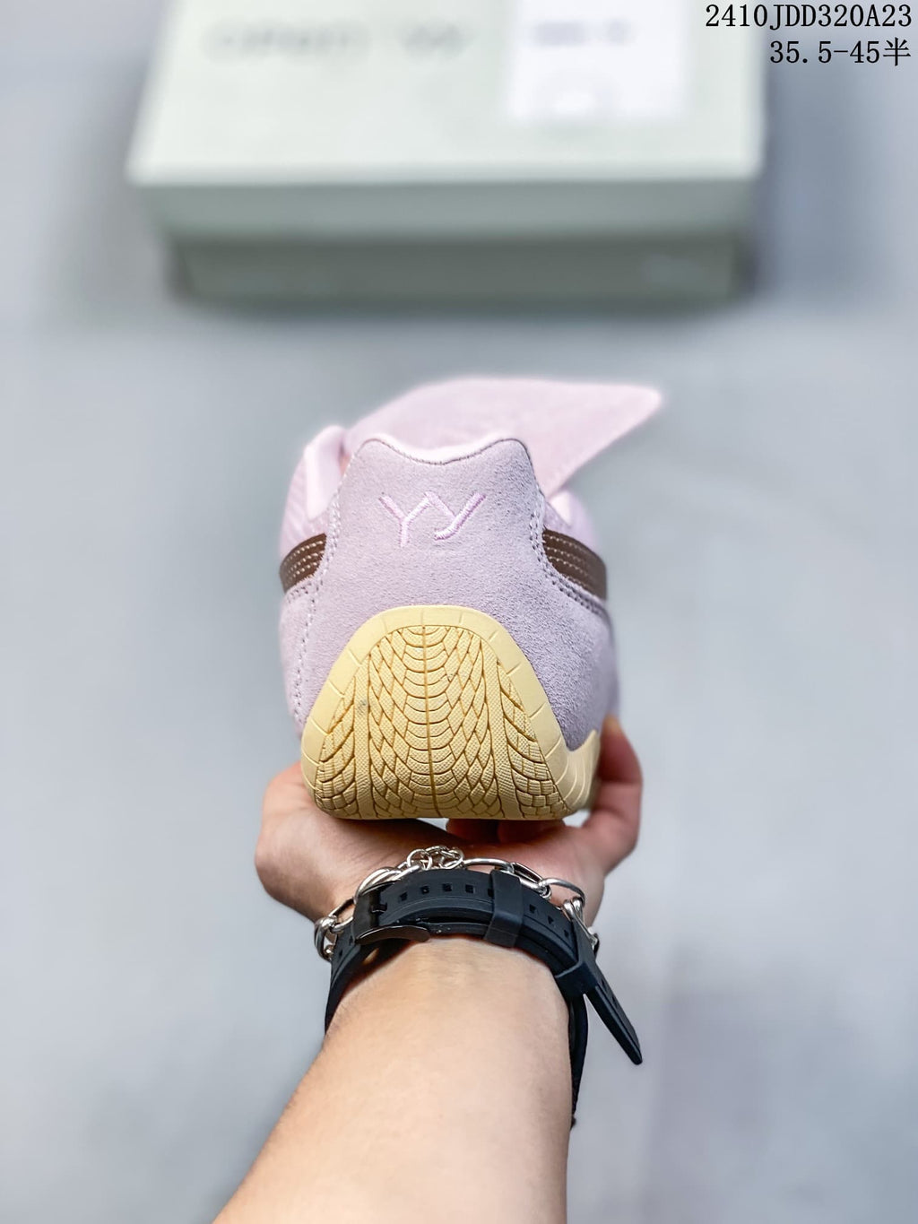 Rear view showing the heel and gum-colored outsole of the pink sneaker