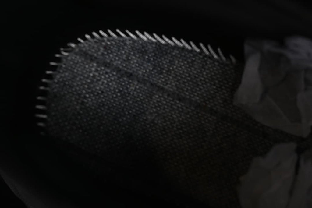 Close-up of the textured toe area of the black sneaker