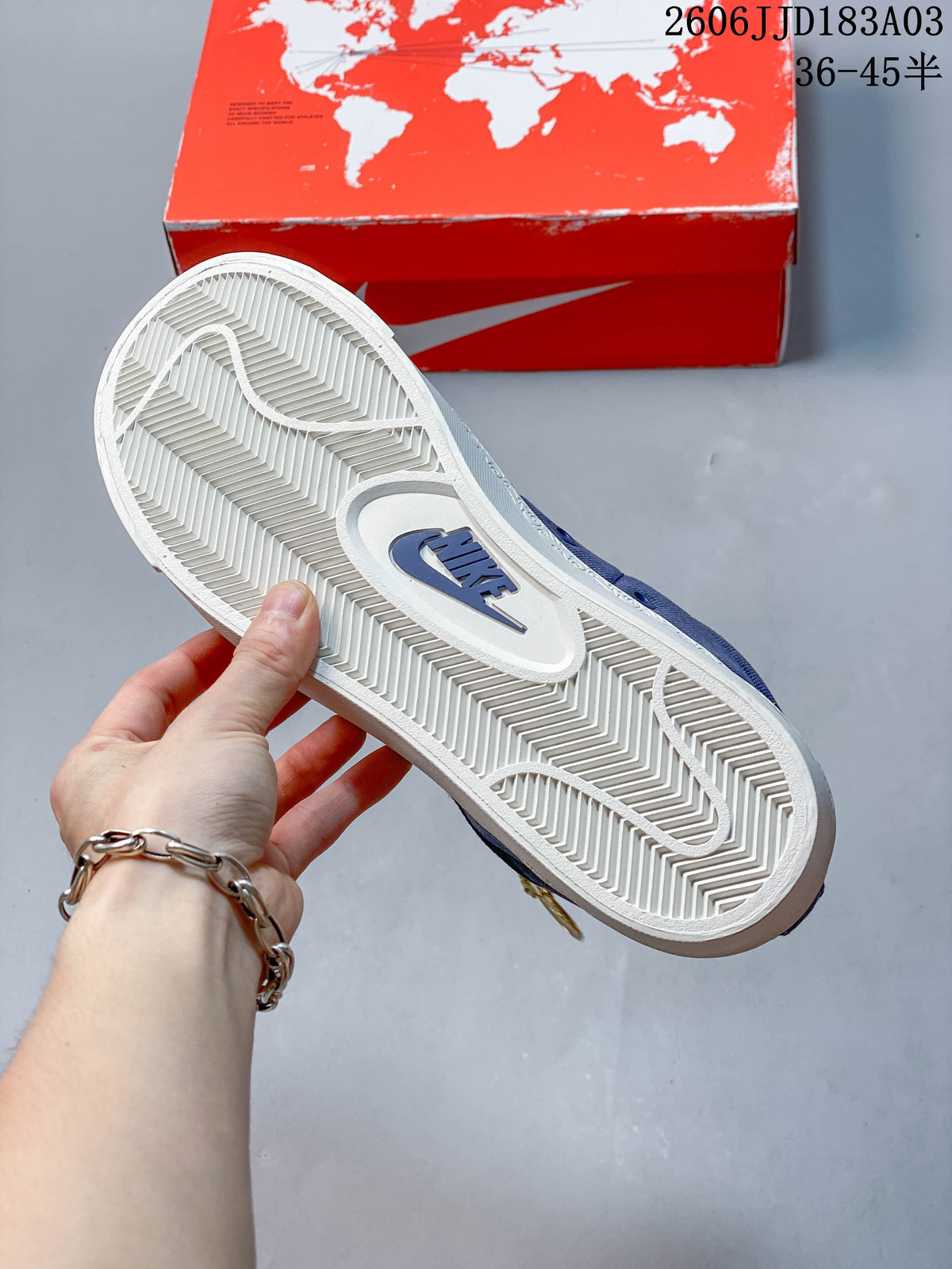 Close-up of the white patterned outsole on a blue sneaker
