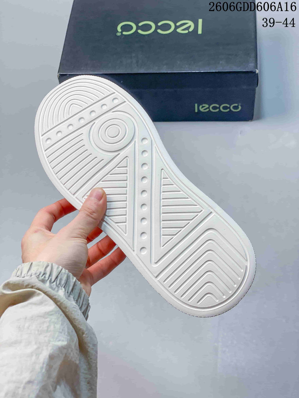 White outsole with molded tread pattern beneath a navy slip-on sneaker