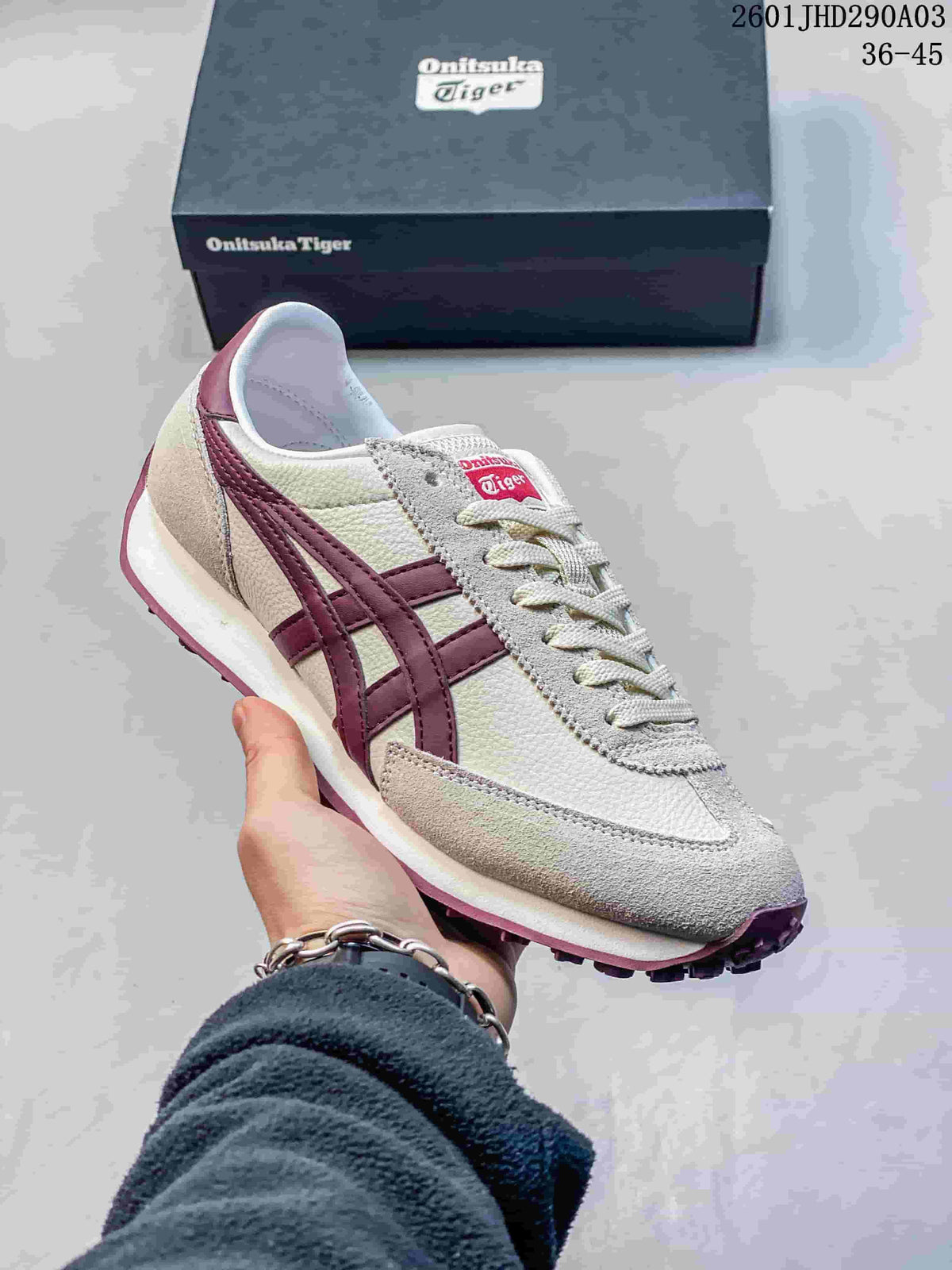 Close-up of a light-colored Onitsuka Tiger EDR 78 sneaker with burgundy side stripes and a shoebox behind it.