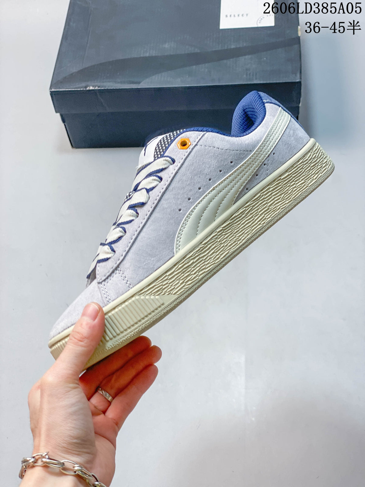 Side view of a gray and blue PUMA Suede XL sneaker with a chunky cream-colored sole