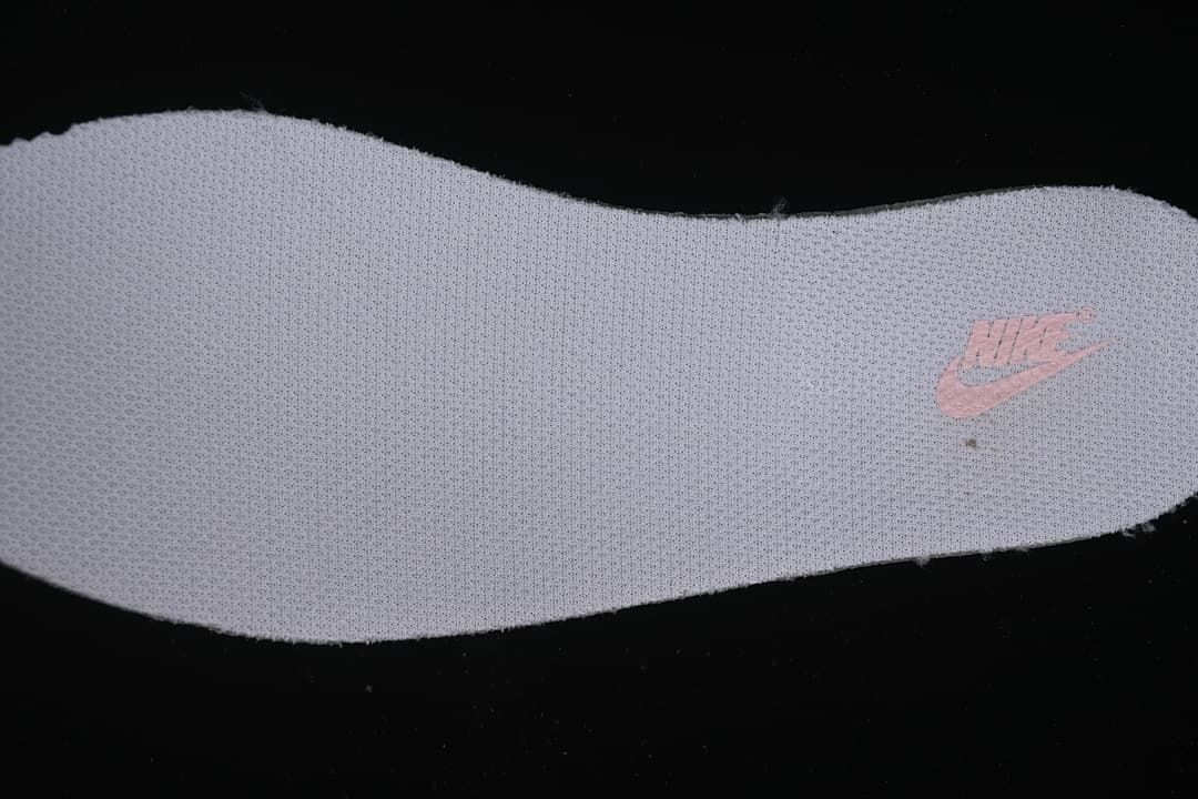 Close-up of a light-colored insole with a pink Nike mark