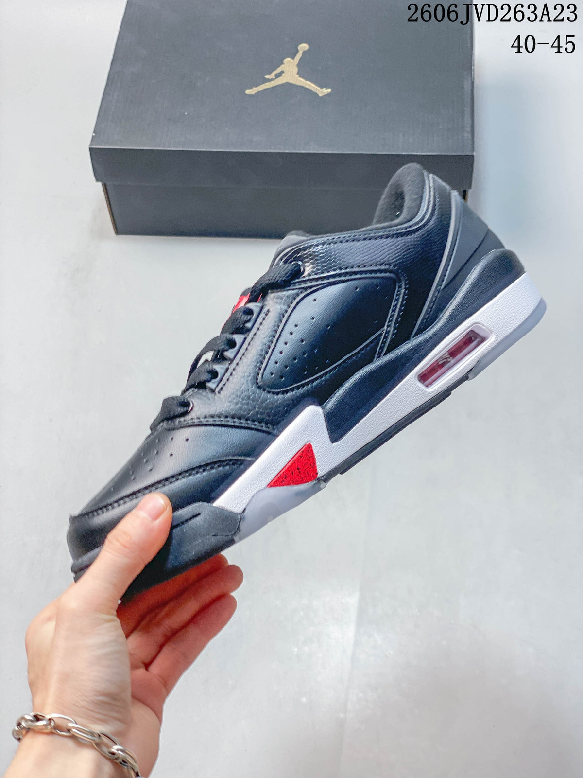 Side view showing perforated panels, red accents, and the white midsole.