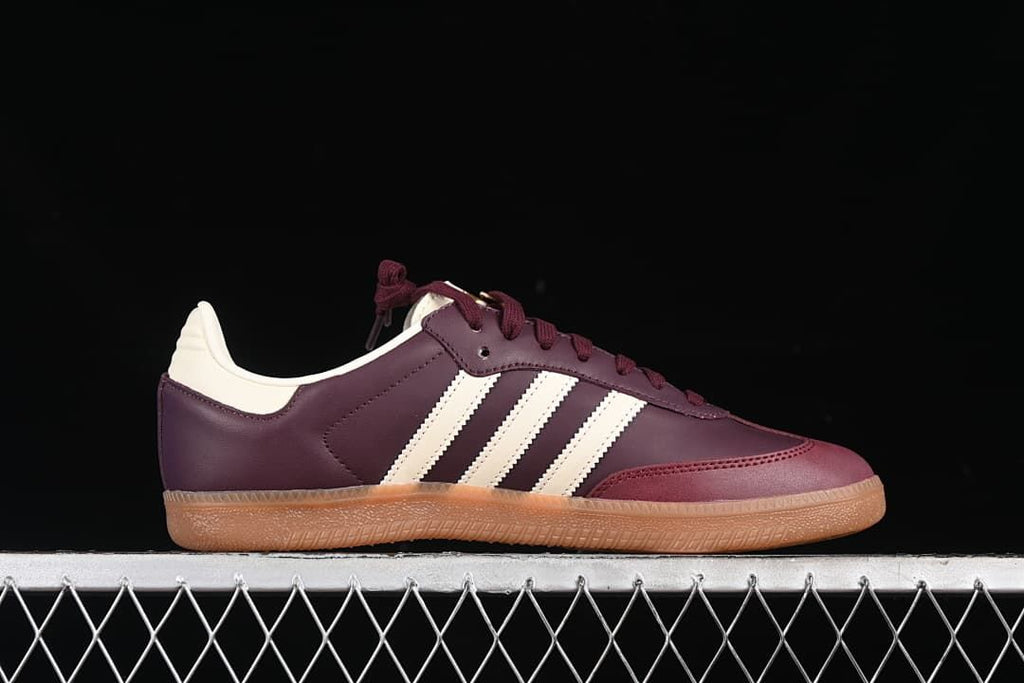 Side profile showing the burgundy upper, cream stripes, and gum sole