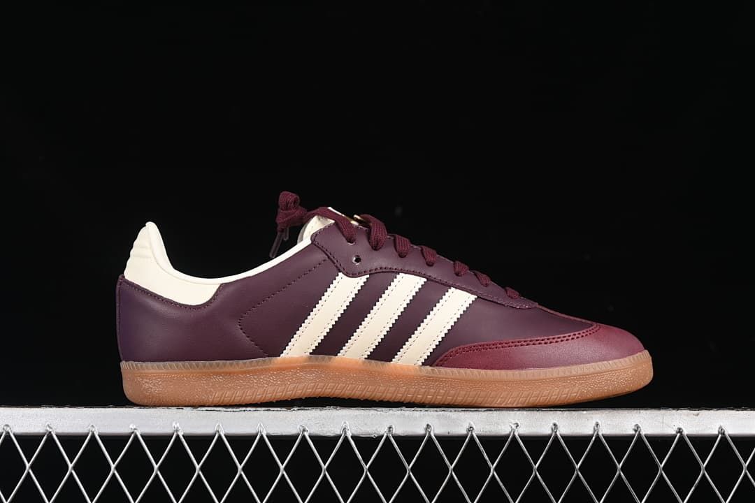 Side profile showing the burgundy upper, cream stripes, and gum sole