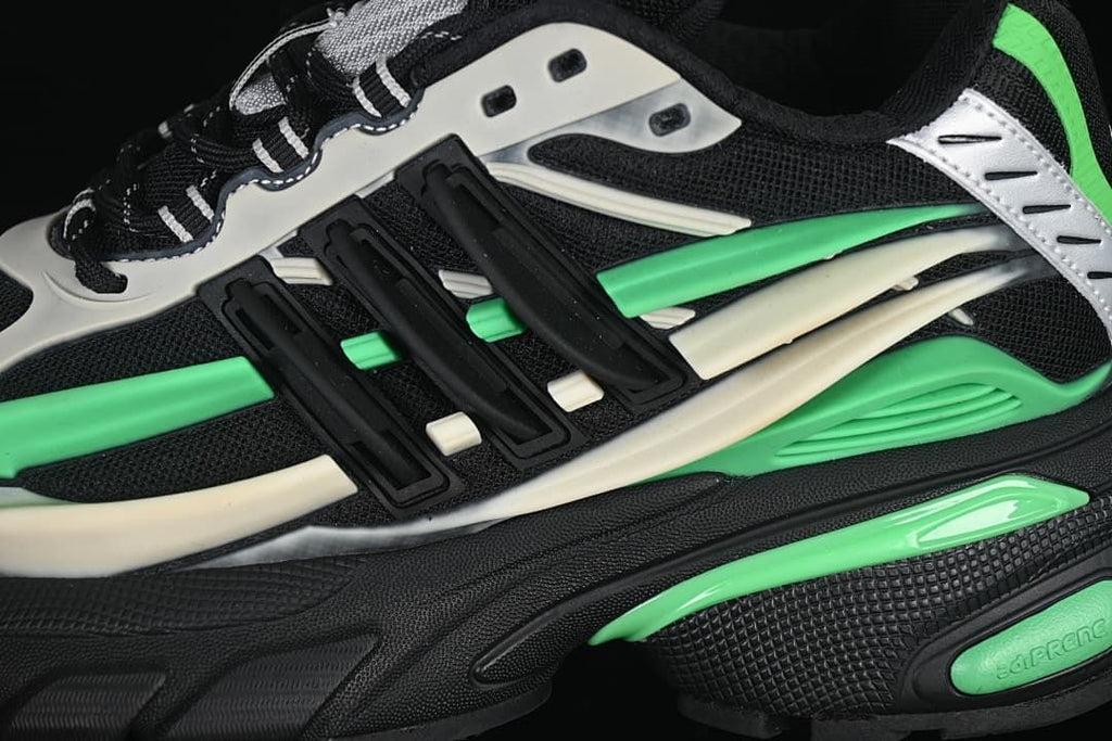 Close-up of the sneaker side with layered black, green and off-white details