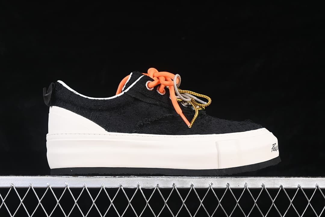 Side profile of a black sneaker with a thick white platform sole
