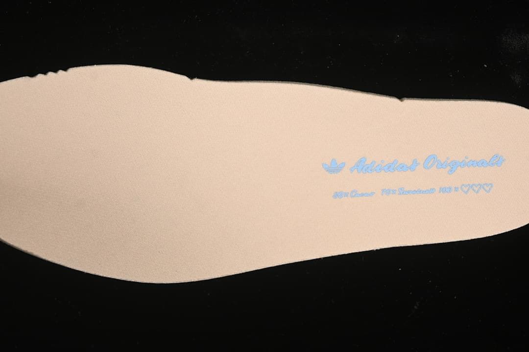 Close-up of a light-colored insole with adidas Originals branding