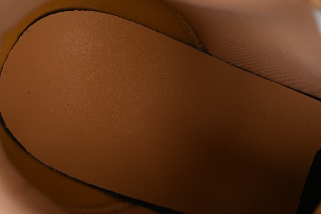 Close-up of the shoe's brown interior lining and footbed.