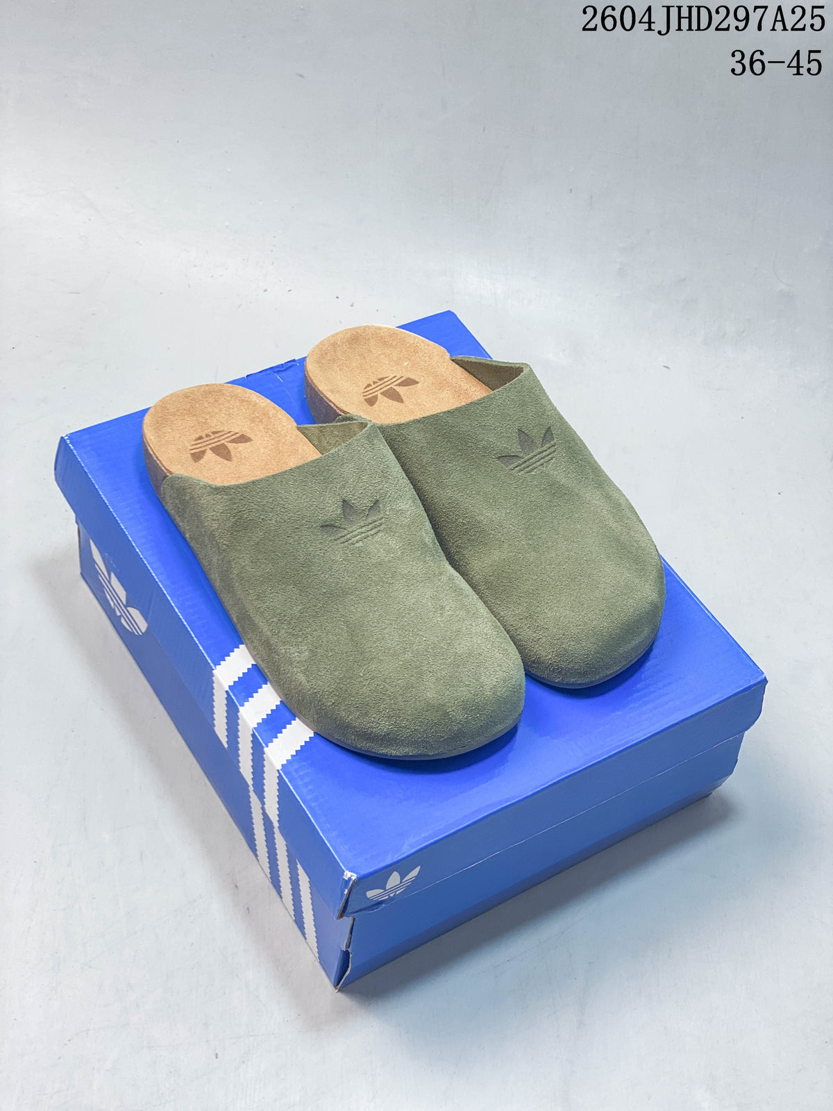 Olive green and light beige Adidas Adimule closed-toe mules displayed on a blue box
