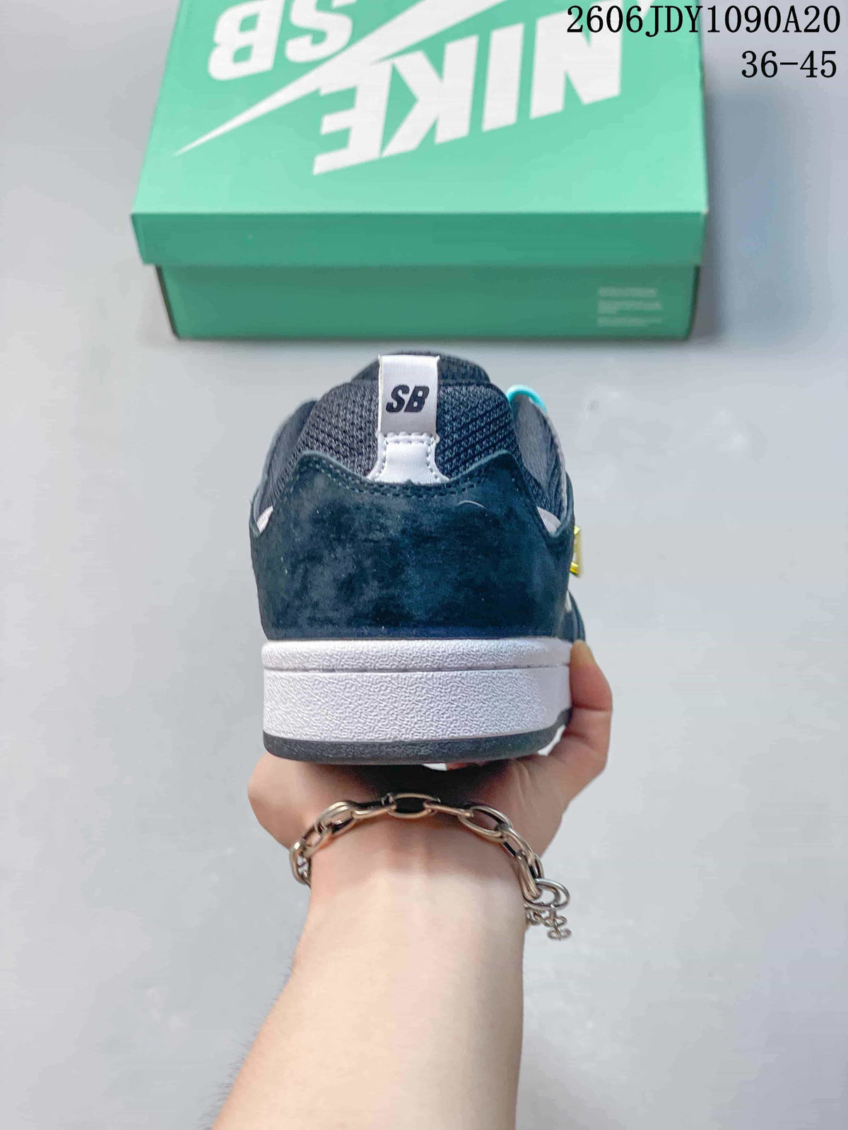 Rear view of a navy Nike SB Alleyoop shoe with a white midsole