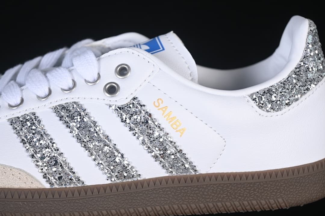 Close-up of the silver glitter-effect stripes, heel accent, and Samba side lettering.