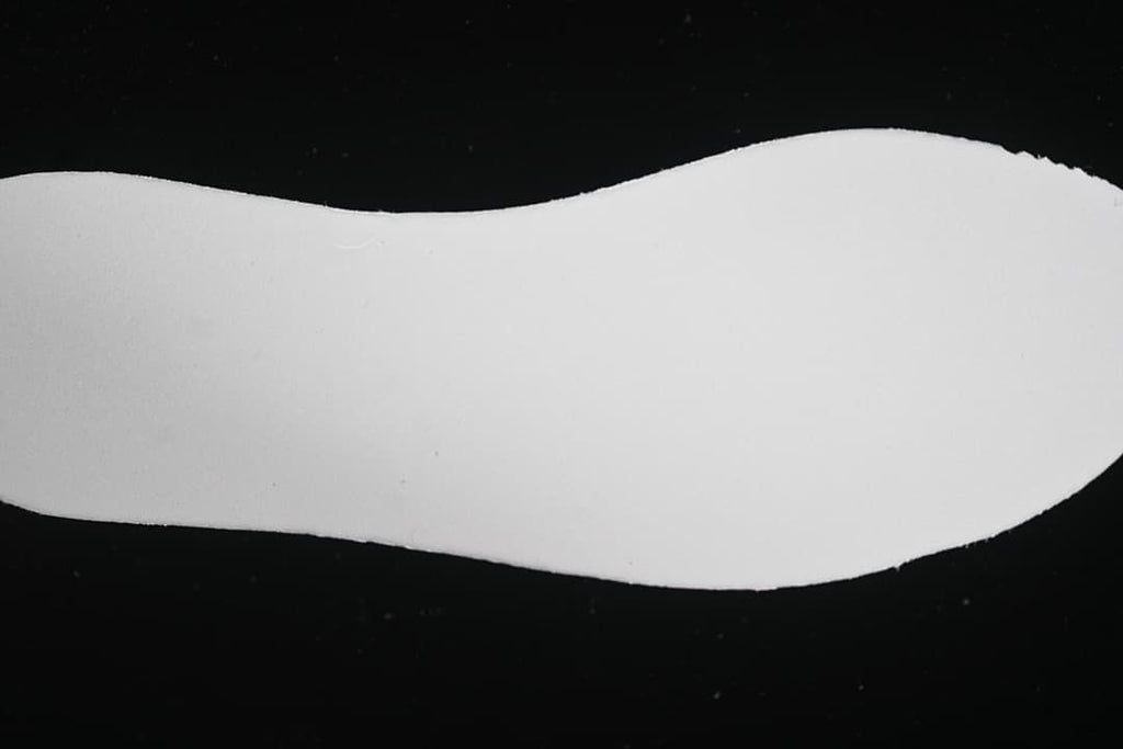 Plain white shoe-shaped insert shown against a black background