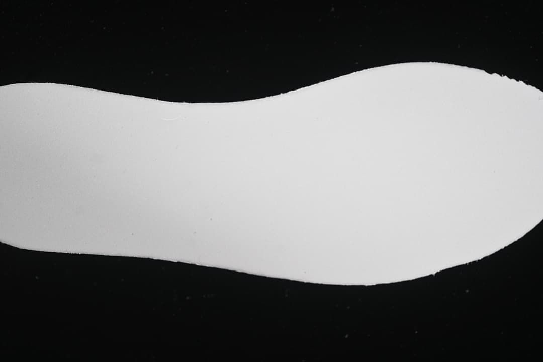 Plain white shoe-shaped insert shown against a black background