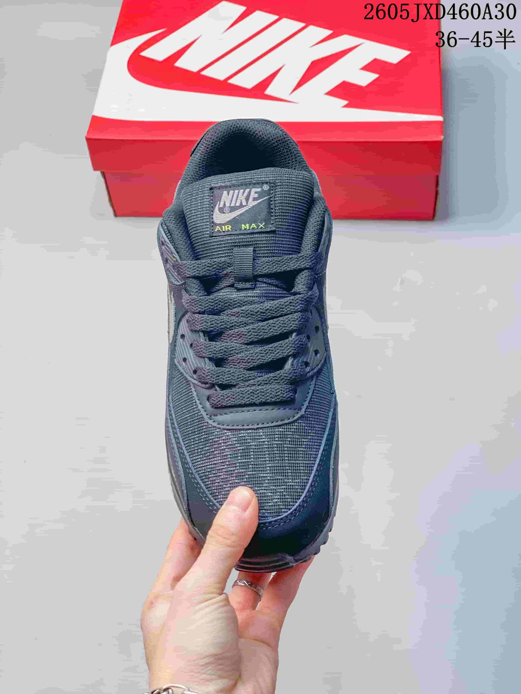 Front view of a charcoal gray Nike Air Max 90 sneaker