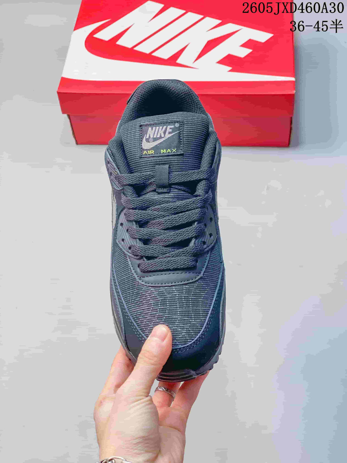 Front view of a charcoal gray Nike Air Max 90 sneaker