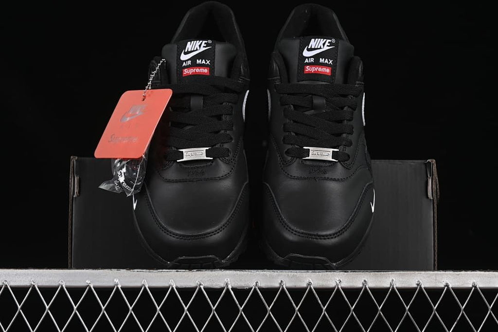Front view of the pair showing tongue labels, black laces and attached hangtag