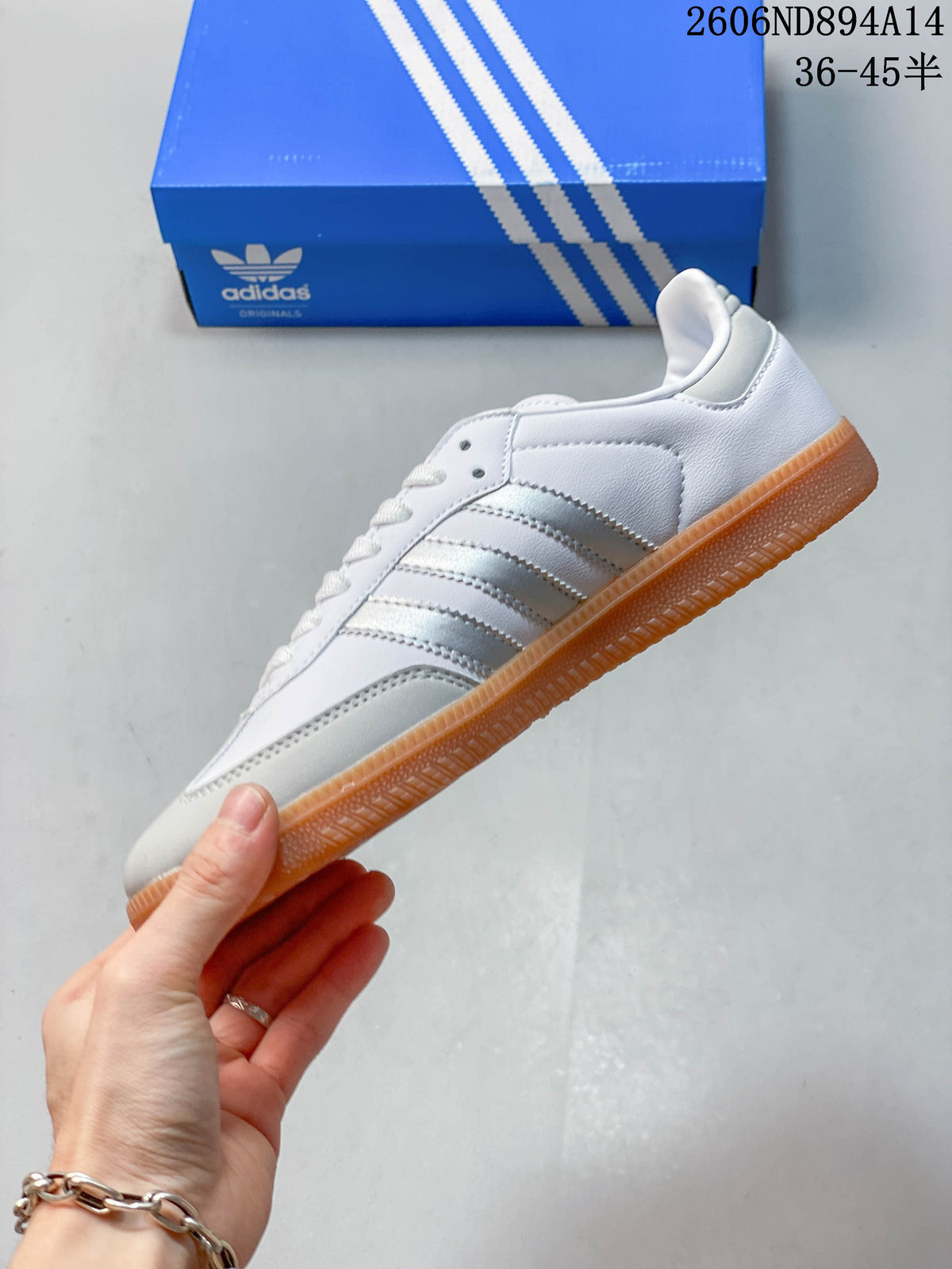 Side profile of a white adidas Samba sneaker with silver stripes and a gum sole