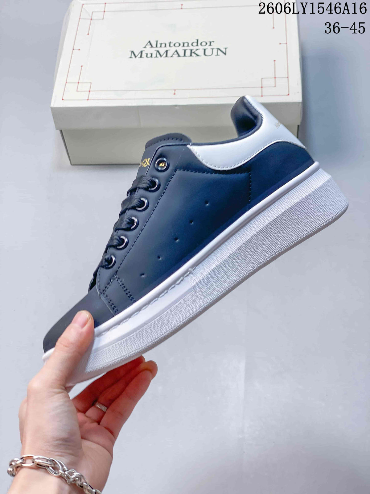 Side view of a navy sneaker with a white heel panel and thick white sole