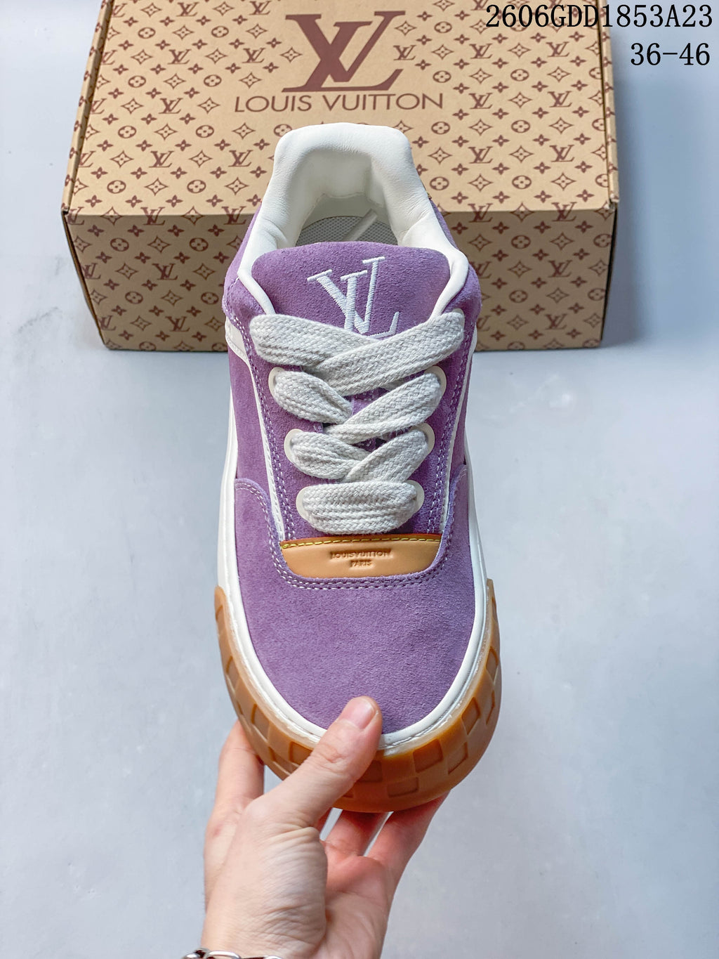 Front view of the purple lace-up sneaker with white laces and tan accent panel