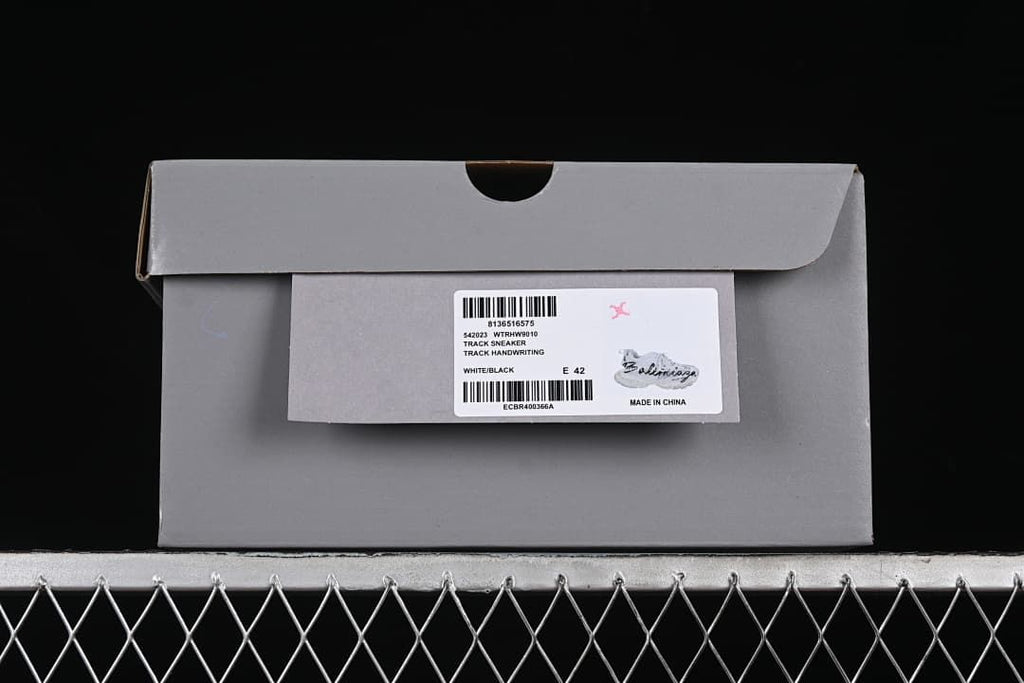 Shoebox label identifying a white and black Track sneaker, size EU 42