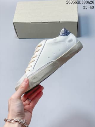 Side view showing the white upper, gray panels, and textured sole