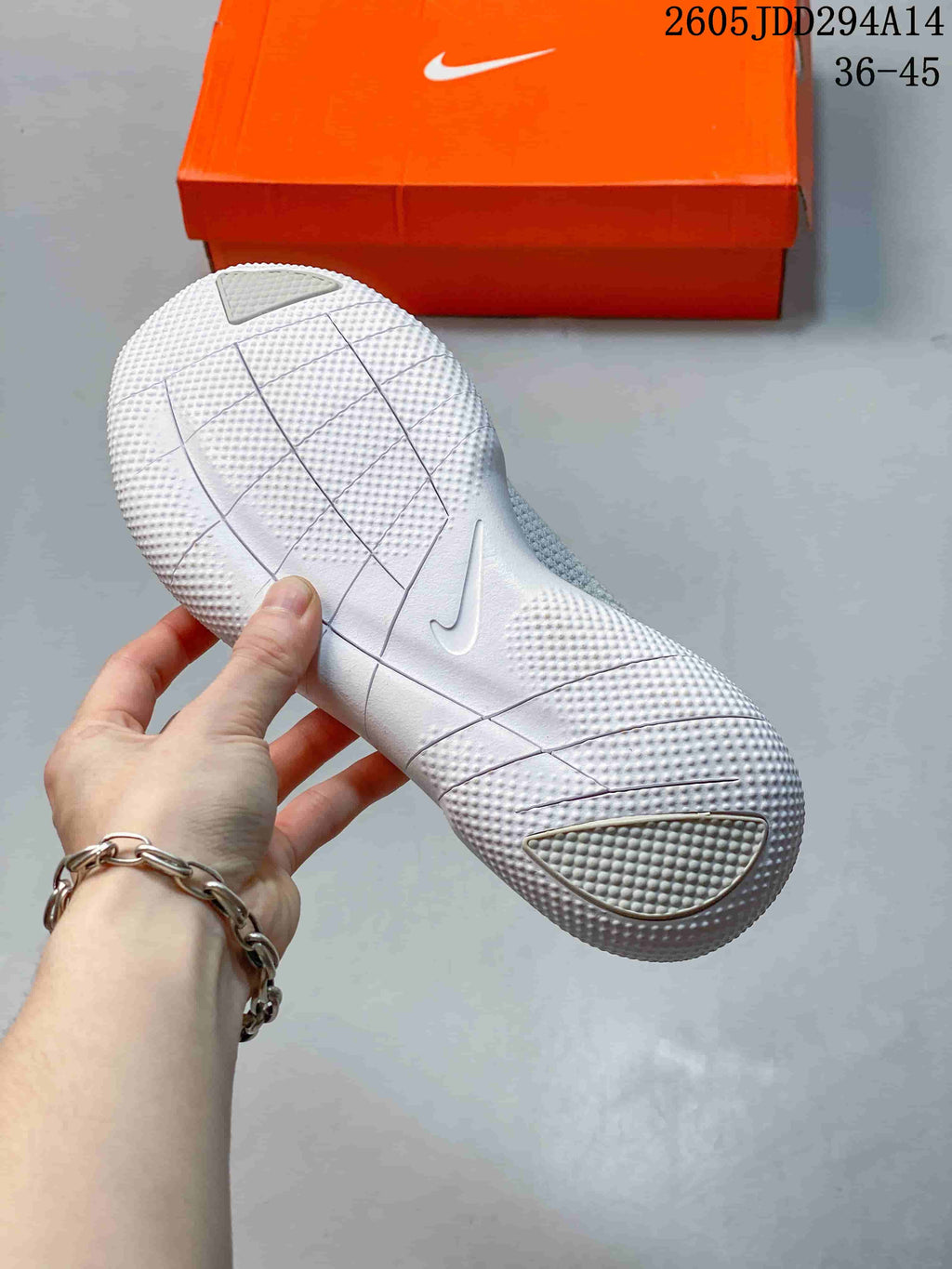 View of the textured, segmented outsole on a light-colored Nike Free shoe