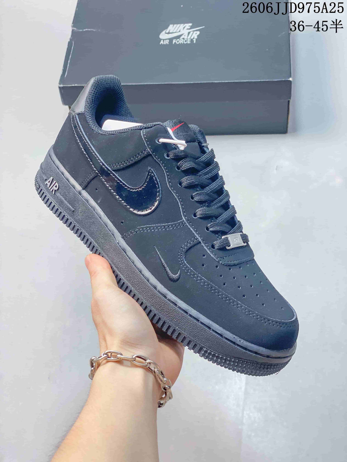 Side view of a dark gray low-top sneaker with perforated panels