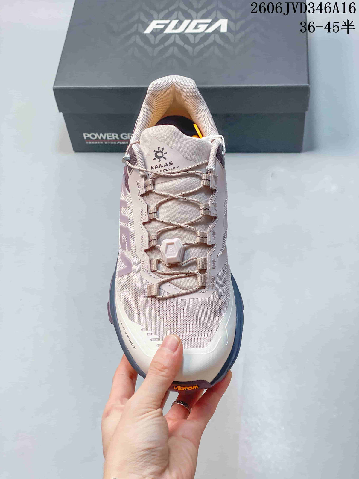 Front view of the shoe showing its lace-up closure, pale pink upper, and white toe area.
