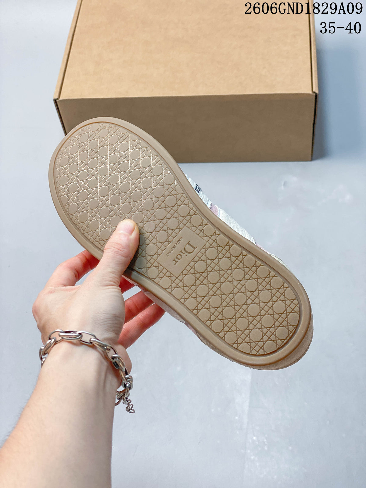Underside of the sneaker showing a patterned gum-tone outsole