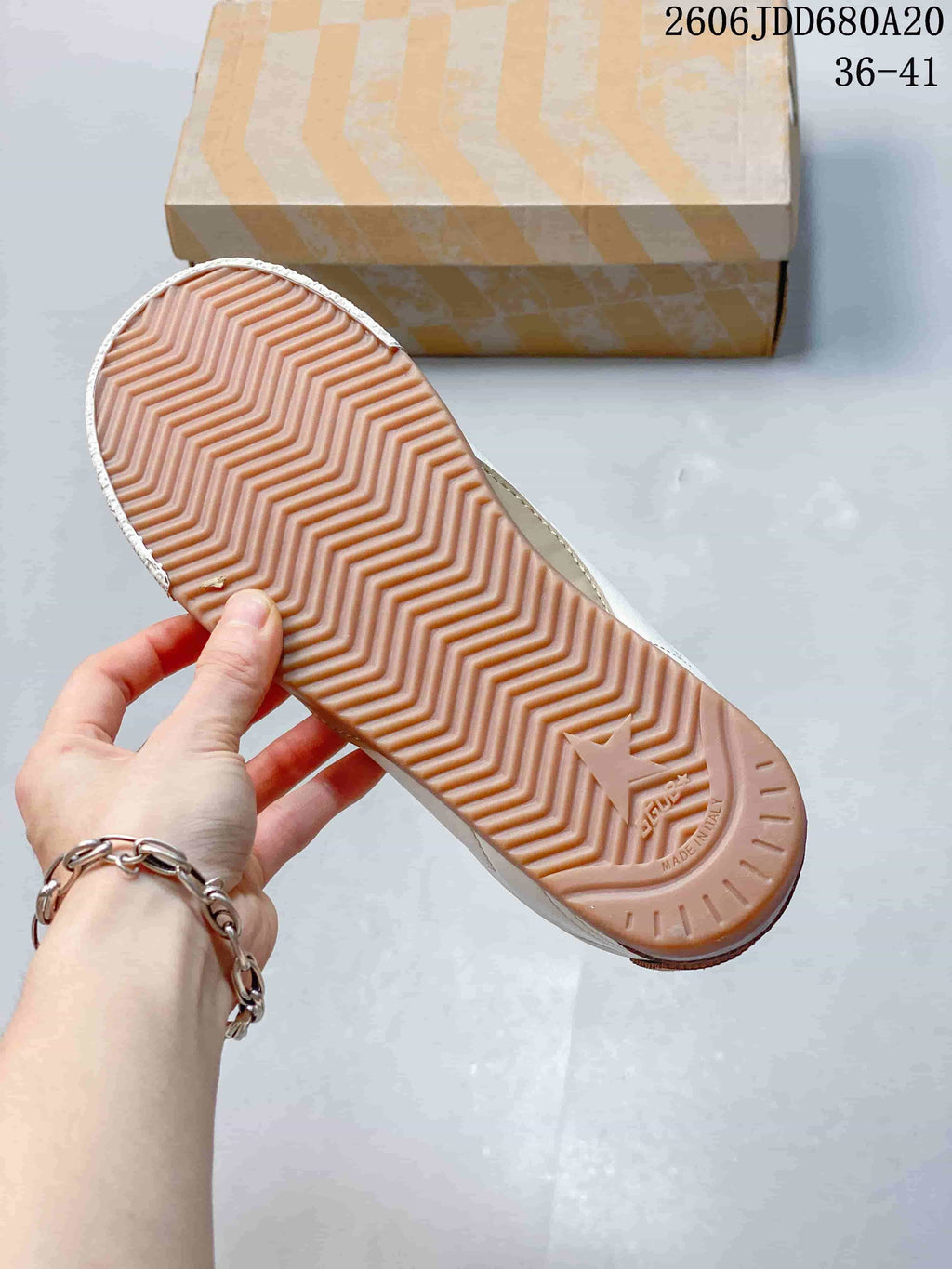 Underside of the sneaker showing a gum-colored patterned outsole