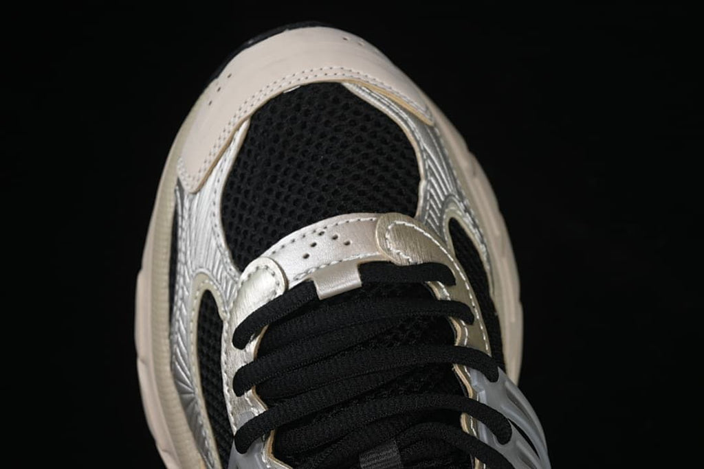 Top-down close-up of the toe, mesh panels and black laces
