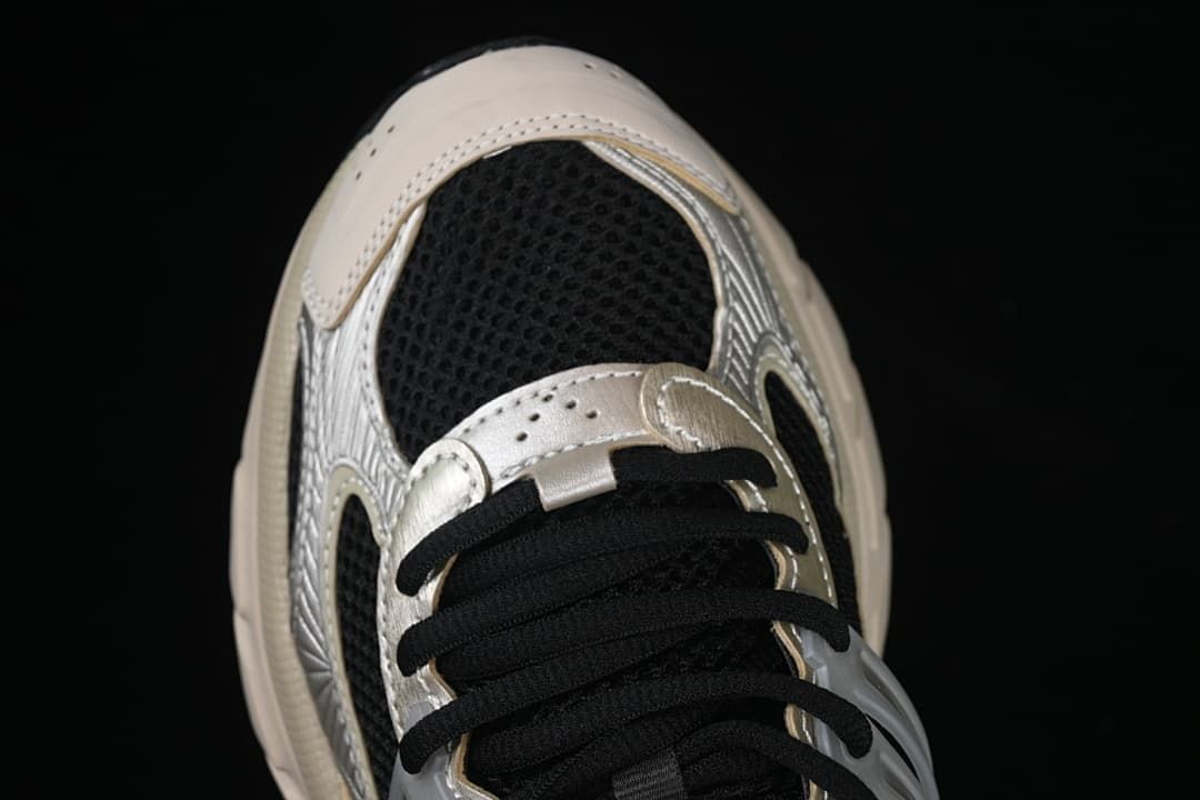 Top-down close-up of the toe, mesh panels and black laces