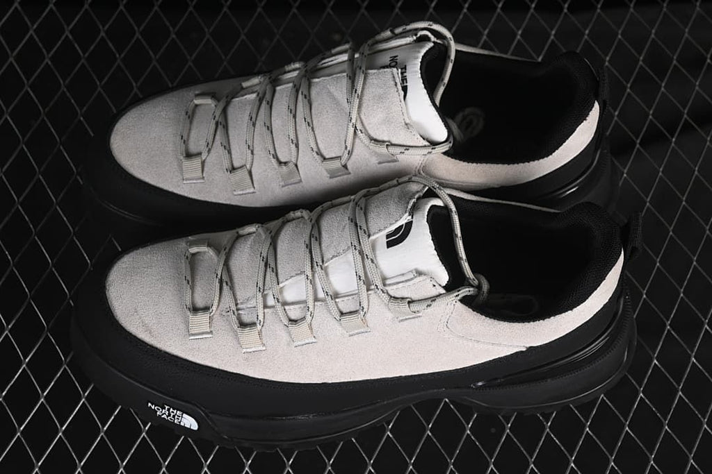 Overhead view of the pair of light grey and black shoes
