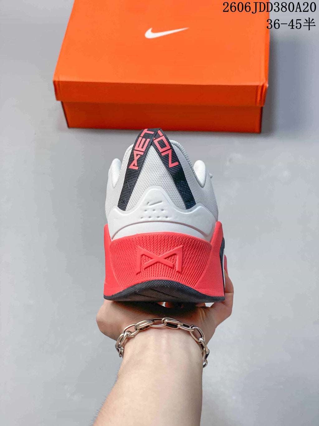 Rear view showing the white heel and coral-red heel section of the Nike Free Metcon 7.