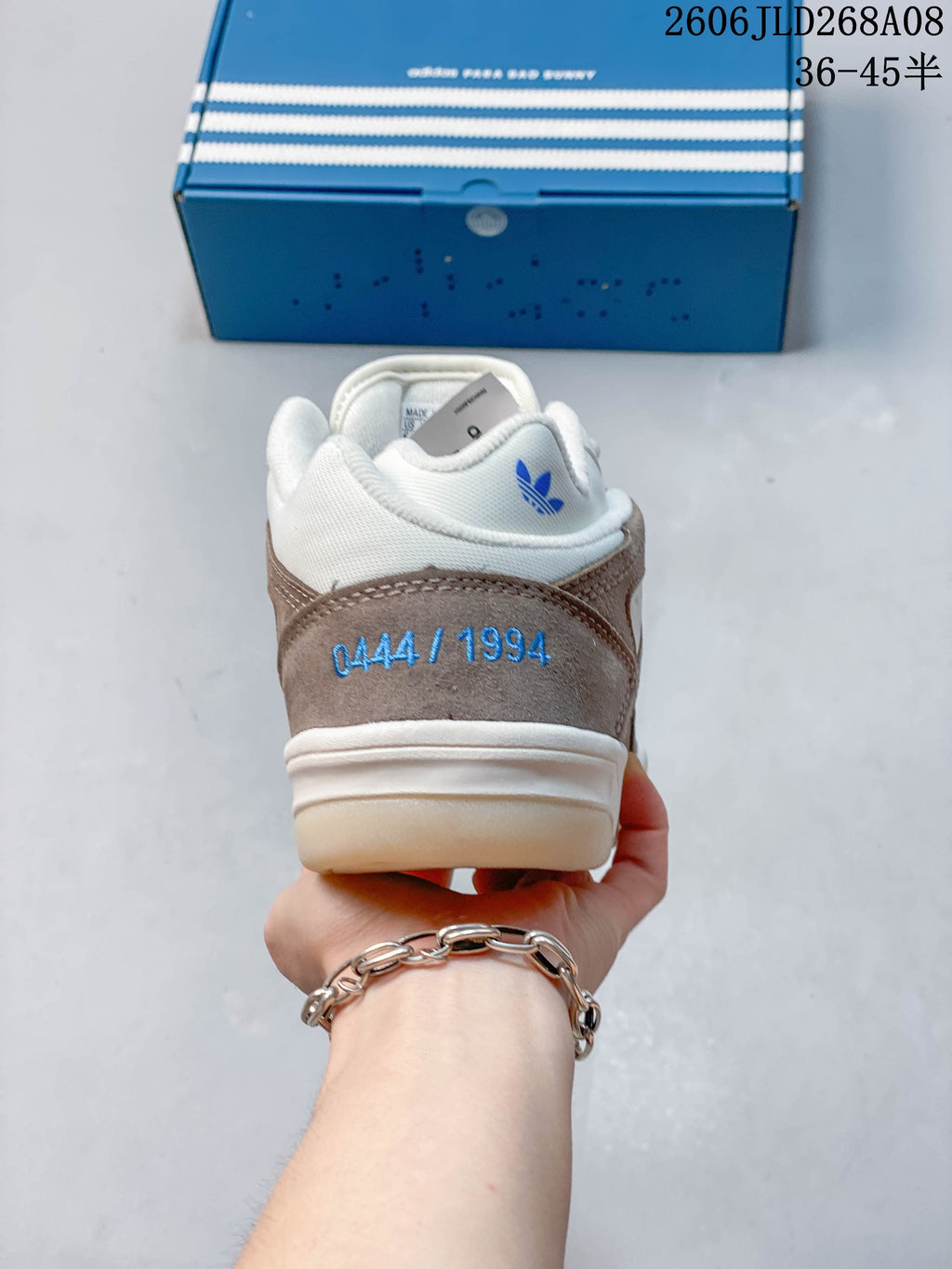 Rear view of the sneaker showing blue heel embroidery and a padded collar