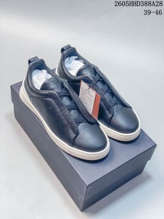 Pair of navy low-top sneakers displayed on a box; box shows size range 39–46.
