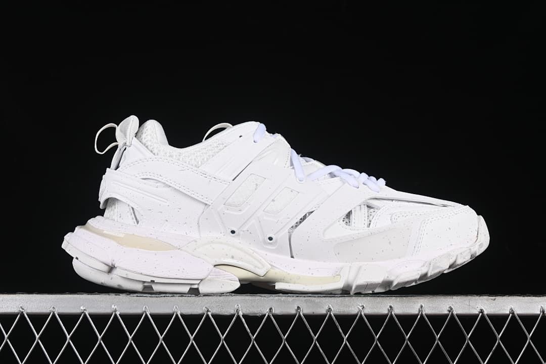 Side profile of a white sneaker with layered panels and chunky sole