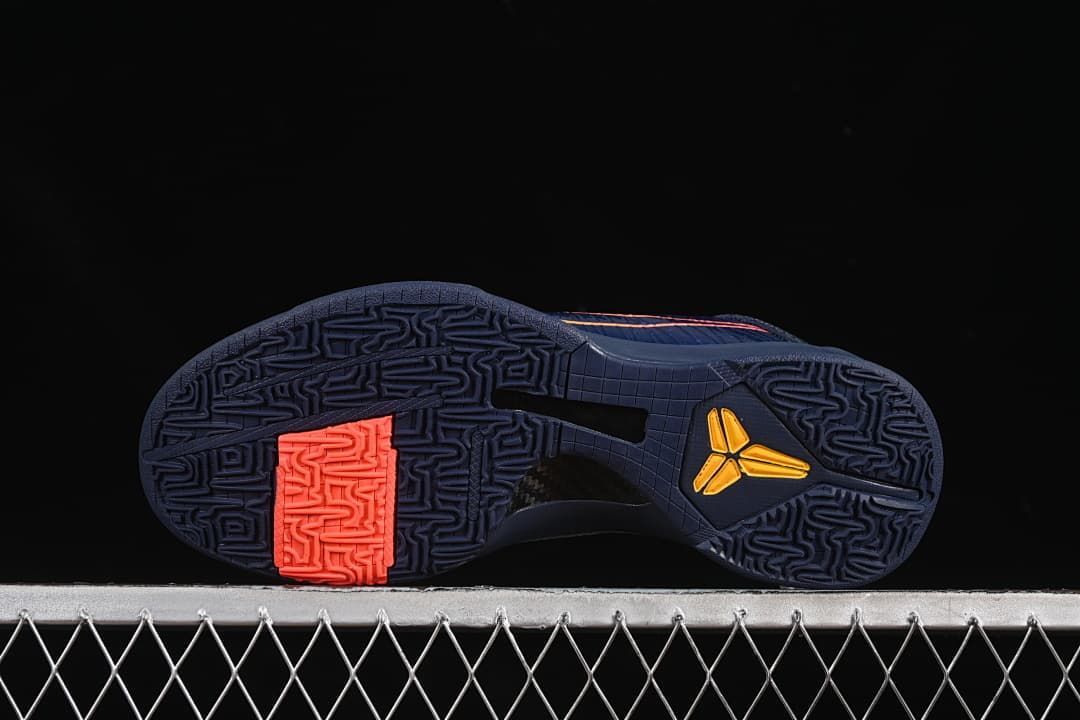 View of the patterned outsole with coral and yellow accents.