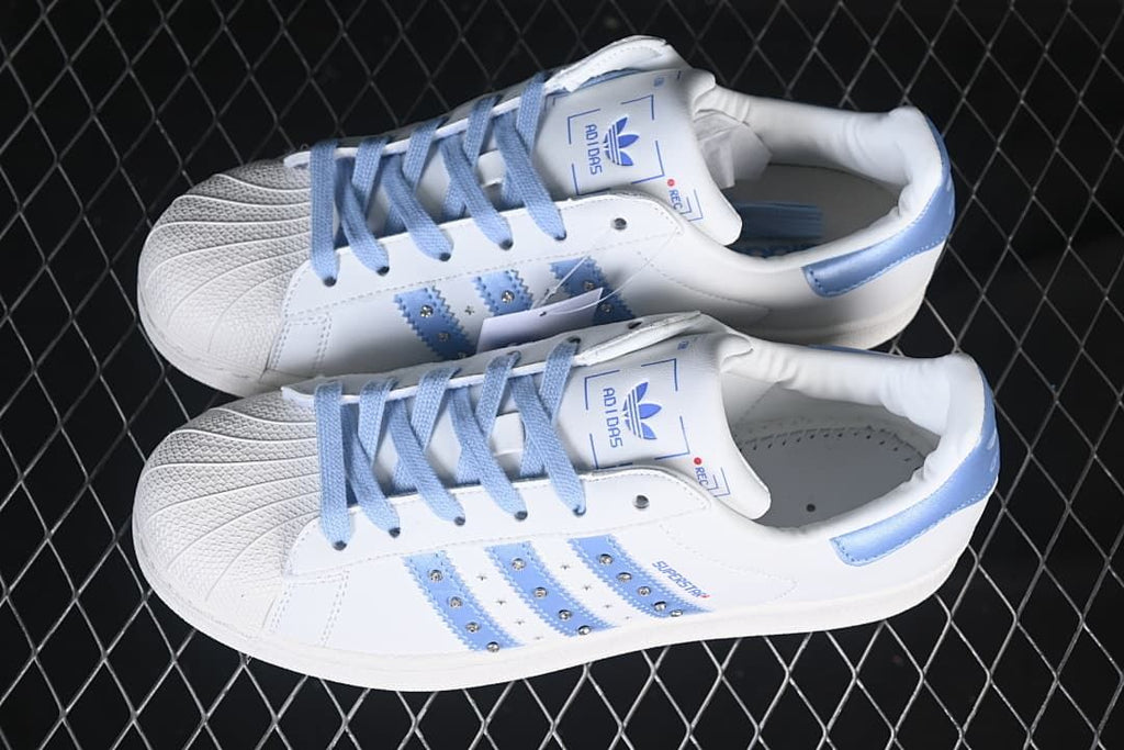 Pair of white and pale blue Superstar II sneakers shown from above.